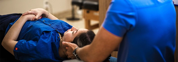 Chiropractor Dan Foss Over The Shoulder Adjusting Patient